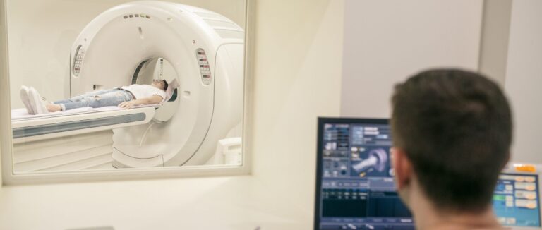 CT Technologist overlooking patient